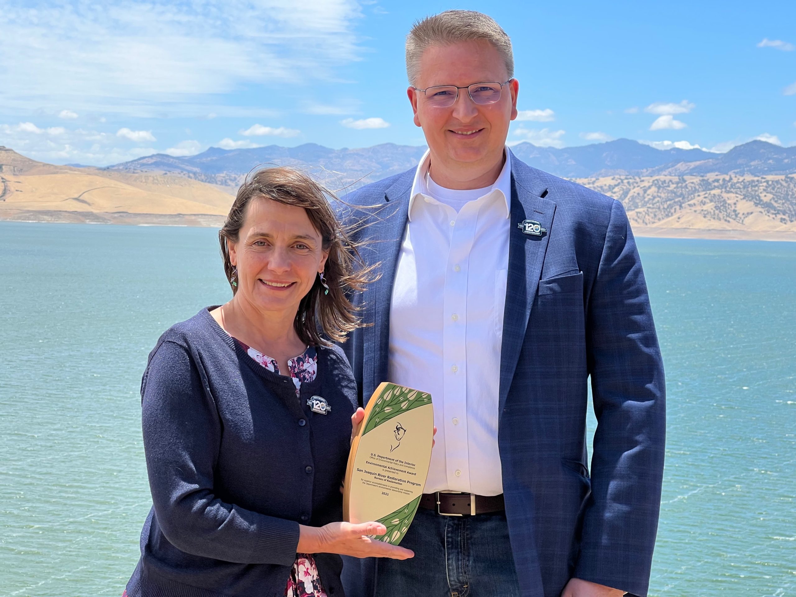 Assistant Secretary of the Interior Tanya Trujillo presents Program Manager Don Portz with an Environmental Achievement Award