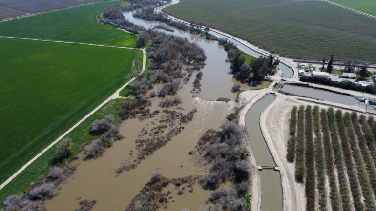 In 2023, Sack Dam was buried beneath flood flows and can be seen by the white wake in the center of the screen. Fish passage facilities will be constructed to the left of the main river channel and around the existing dam.